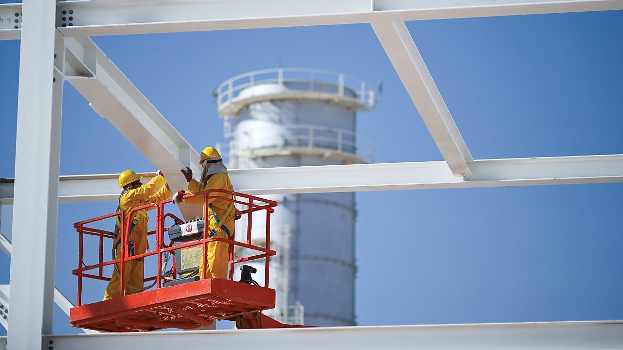 Two engineers on crane doing maintenance work